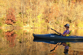 One Canoe on River during Fall